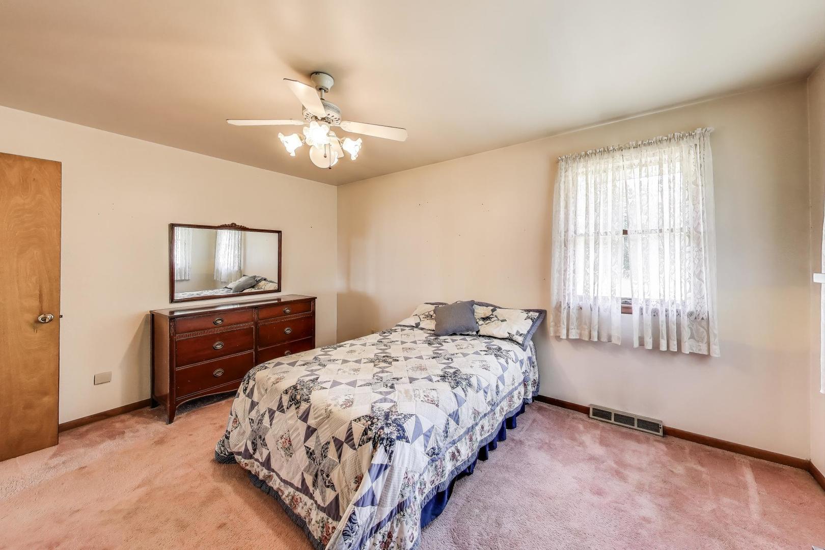 7008 West Kennedy Road Peotone, IL 60468 - Photo 26 of 41 a bedroom with a bed and a dresser in it