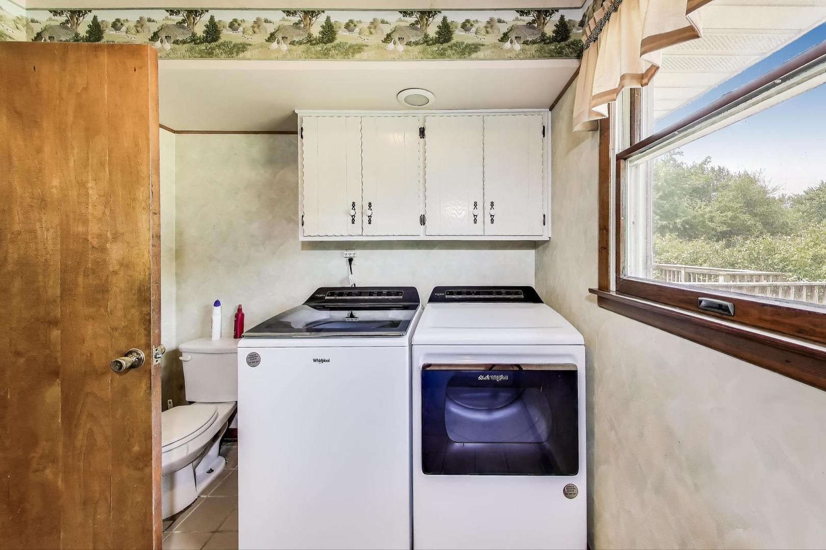 7008 West Kennedy Road Peotone, IL 60468 - Photo 27 of 41 a view of washer and dryer with kitchen in the background