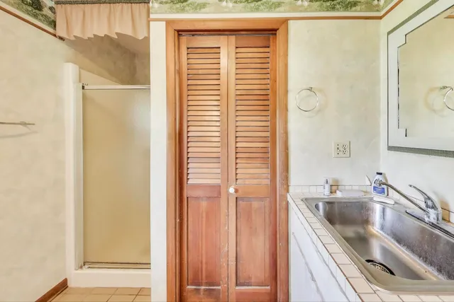 a kitchen with a sink a refrigerator and cabinets