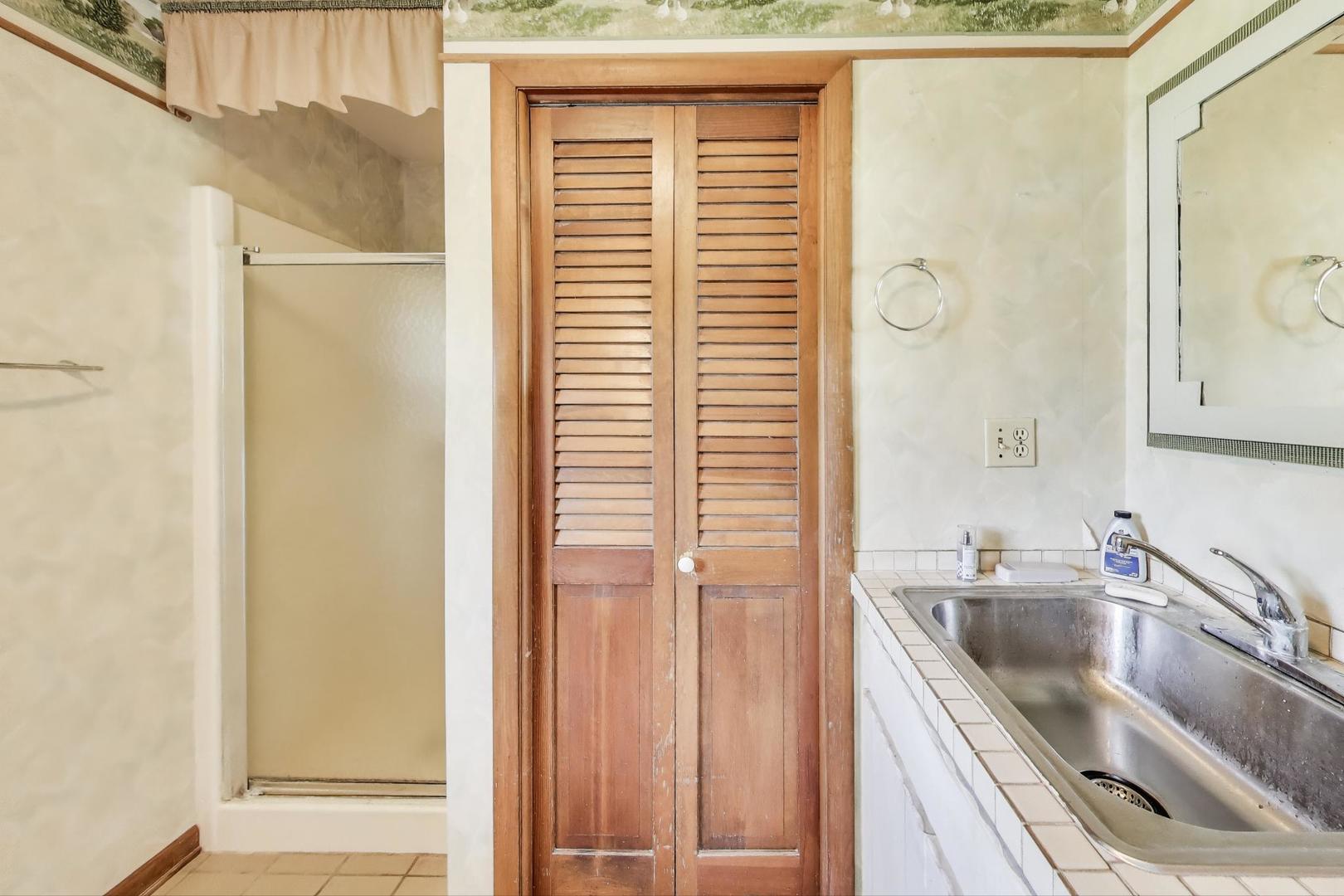 7008 West Kennedy Road Peotone, IL 60468 - Photo 28 of 41 a kitchen with a sink a refrigerator and cabinets