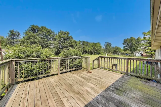 a balcony with wooden floor and fence