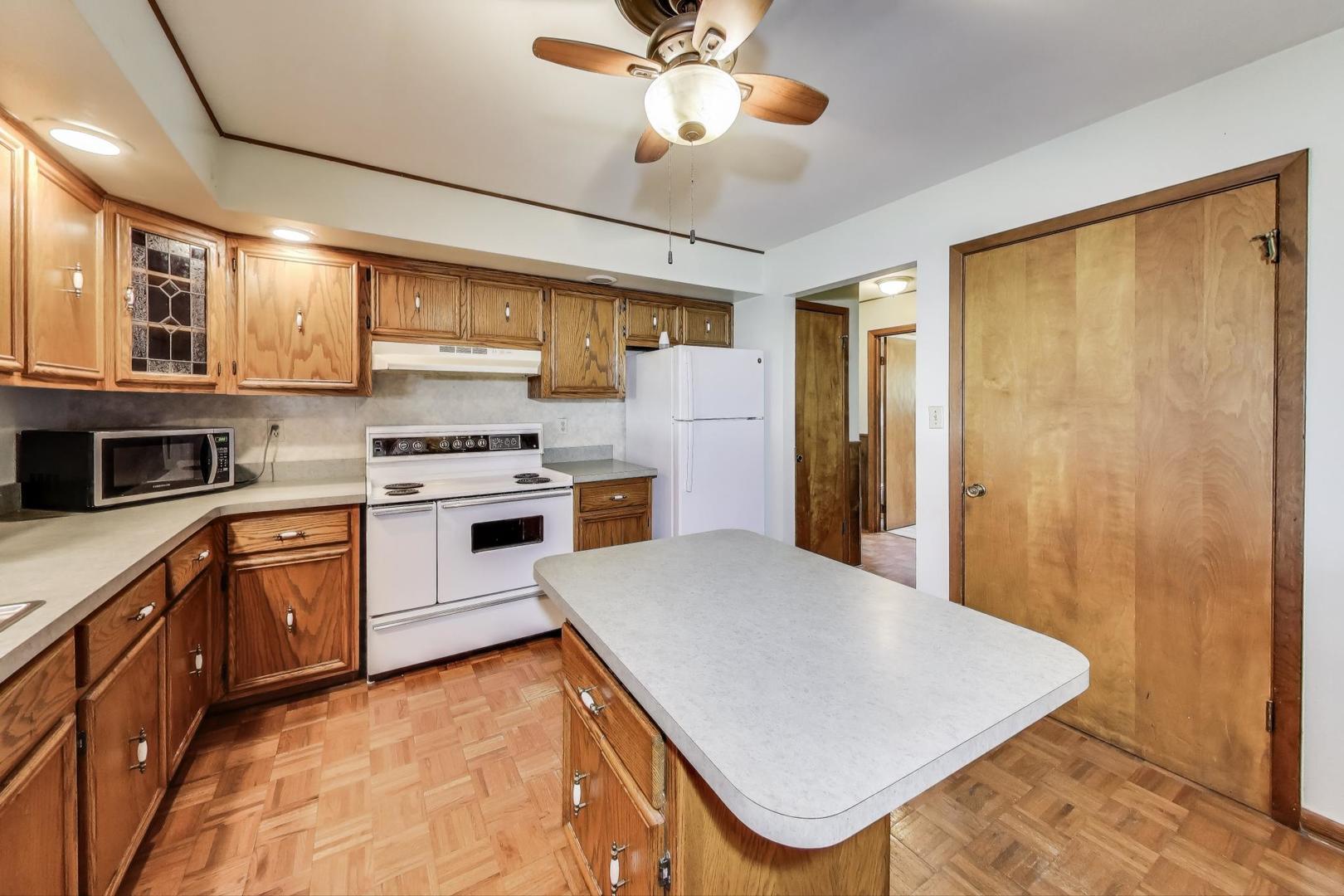 7008 West Kennedy Road Peotone, IL 60468 - Photo 9 of 41 a kitchen with stainless steel appliances a stove a sink dishwasher and a refrigerator
