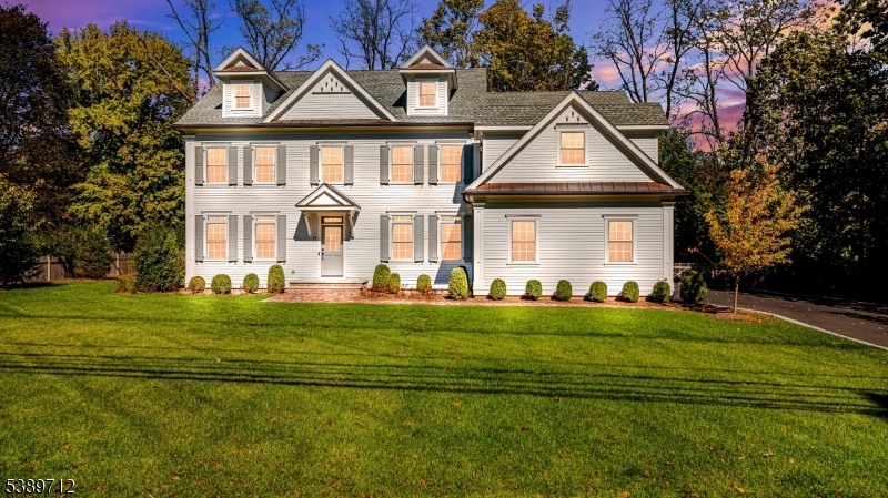a front view of a house with a yard table and chairs