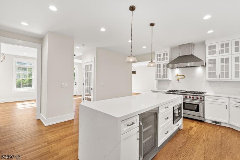 91 Woodland Road Madison, NJ 07940 - Photo 13 of 49 a large kitchen with stainless steel appliances granite countertop a stove and a refrigerator