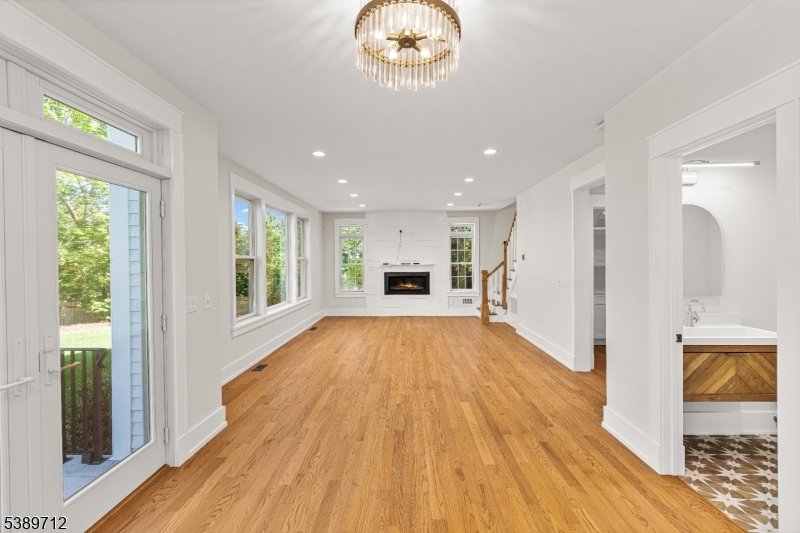 91 Woodland Road Madison, NJ 07940 - Photo 2 of 49 a view of an empty room with wooden floor and a window