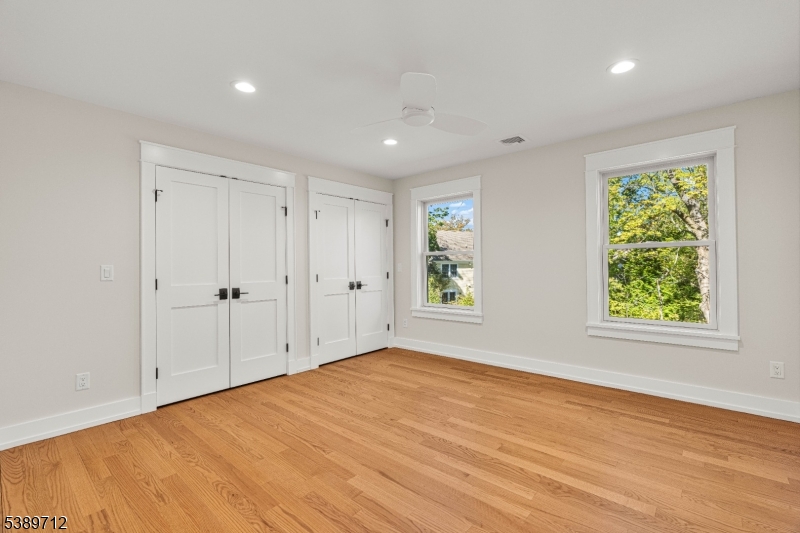 91 Woodland Road Madison, NJ 07940 - Photo 24 of 49 a view of an empty room with wooden floor and a window