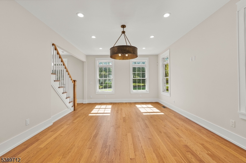 91 Woodland Road Madison, NJ 07940 - Photo 3 of 49 a view of an empty room with window and wooden floor