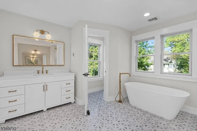 a bathroom with a sink toilet vanity and shower