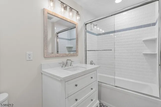 a bathroom with a double vanity sink and mirror with shower