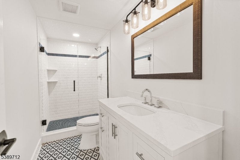 91 Woodland Road Madison, NJ 07940 - Photo 41 of 49 a bathroom with a sink a toilet and shower