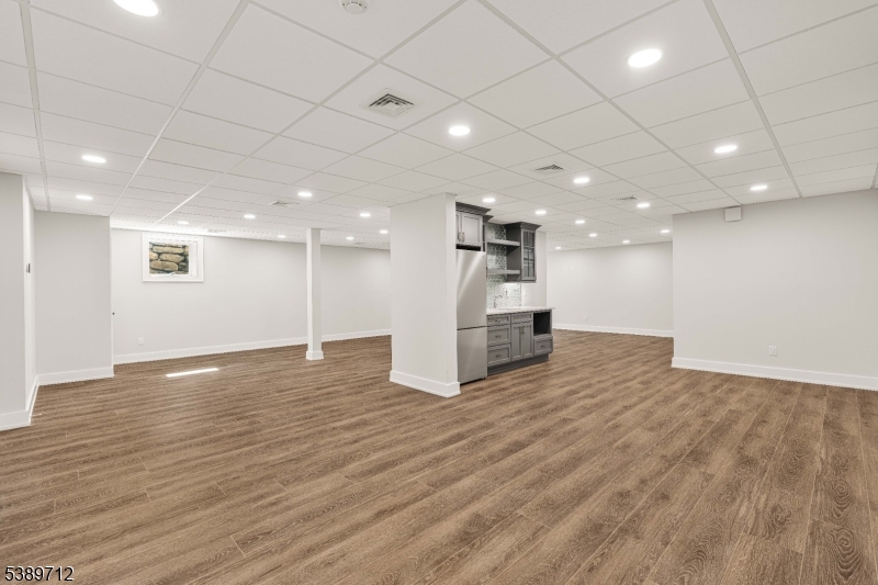 91 Woodland Road Madison, NJ 07940 - Photo 42 of 49 a view of an empty room with wooden floor