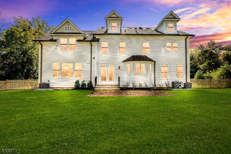 91 Woodland Road Madison, NJ 07940 - Photo 44 of 49 a front view of a house with a yard