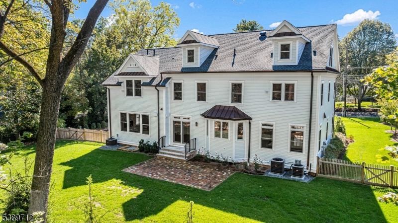 91 Woodland Road Madison, NJ 07940 - Photo 45 of 49 a view of a white house with a big yard and large trees