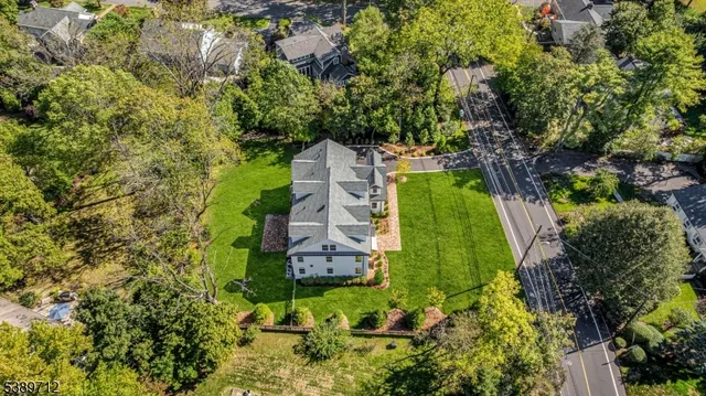 an aerial view of a house with yard and green space