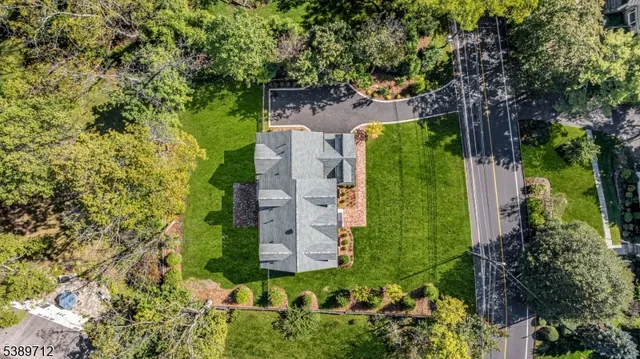 an aerial view of a house with yard swimming pool and outdoor seating