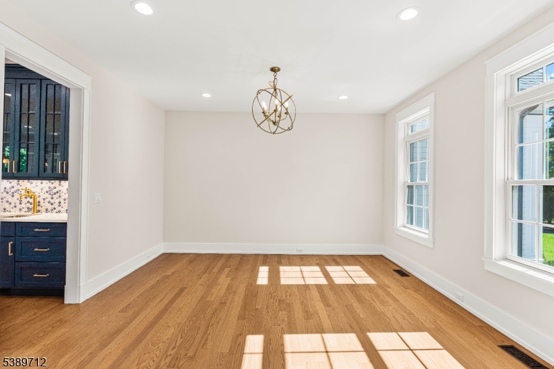 91 Woodland Road Madison, NJ 07940 - Photo 8 of 49 a view of empty room with wooden floor and fan