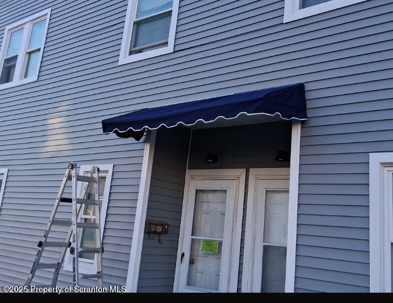 258 Main Street, Unit 1 Dupont, PA 18641 - Photo 1 of 7 a view of a house with a door and wooden roof