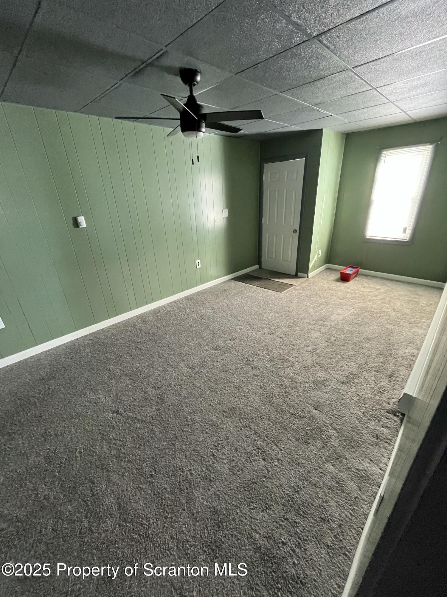 258 Main Street, Unit 1 Dupont, PA 18641 - Photo 2 of 7 a view of a hallway with a ceiling fan and window