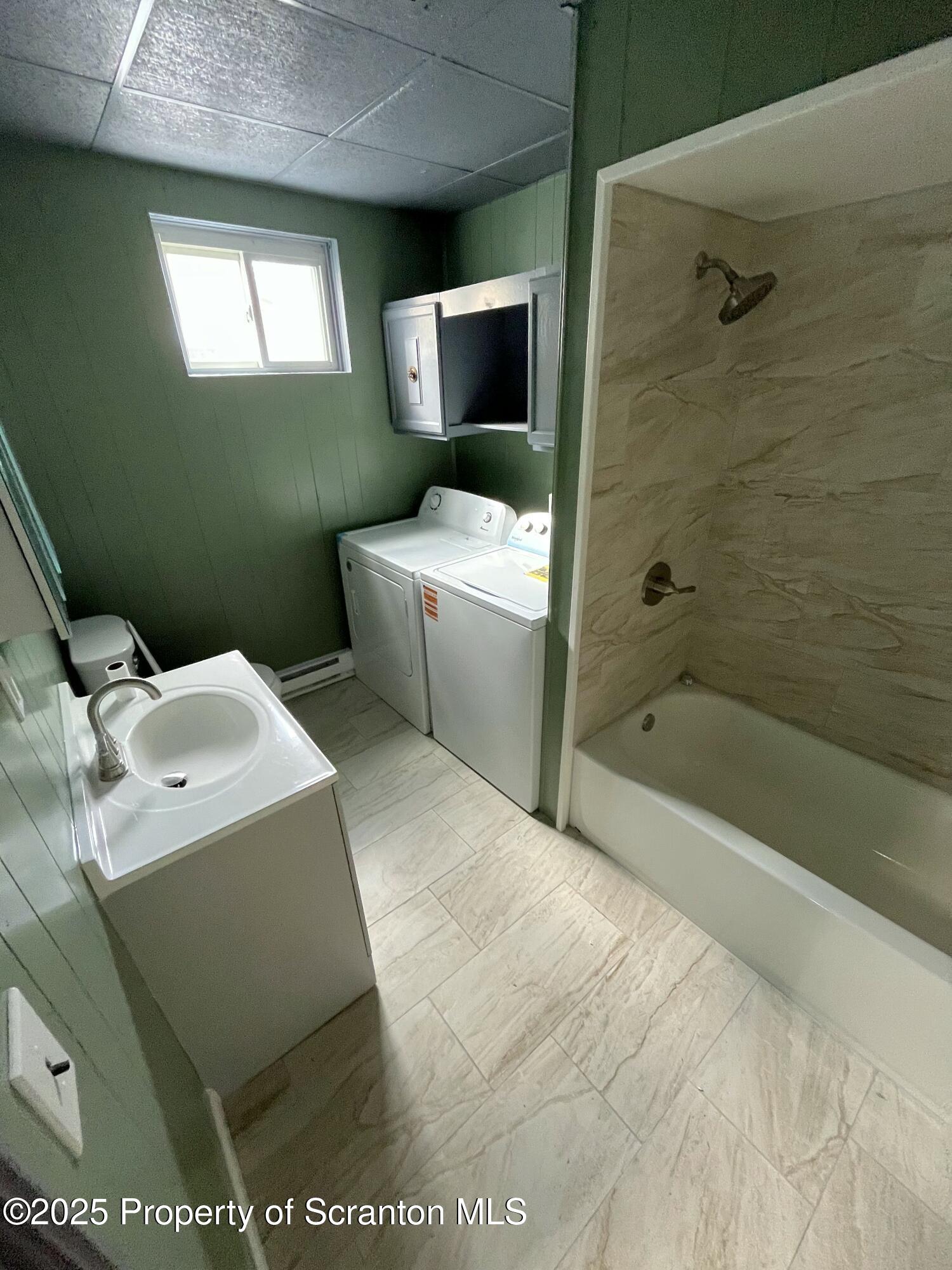 258 Main Street, Unit 1 Dupont, PA 18641 - Photo 6 of 7 a bathroom with a toilet sink and mirror