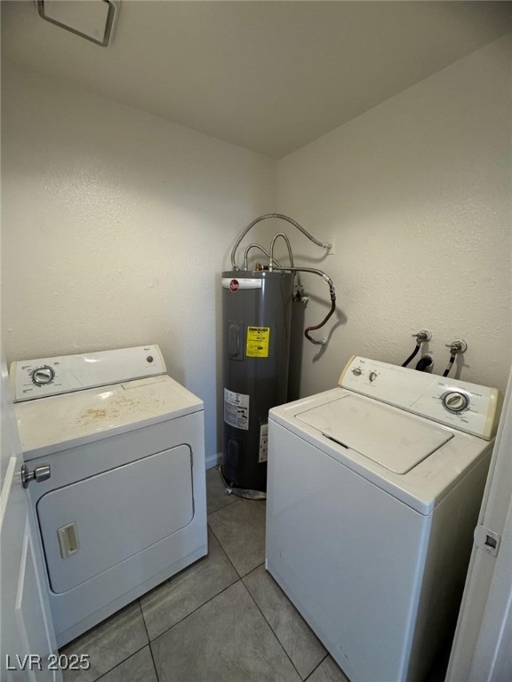 2732 Alicialynn Way, Unit A Las Vegas, NV 89121 - Photo 12 of 14 Laundry area featuring electric water heater, separate washer and dryer, and light tile patterned floors