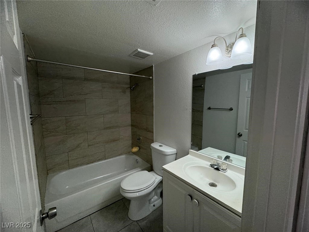 2732 Alicialynn Way, Unit A Las Vegas, NV 89121 - Photo 3 of 14 Bathroom with a textured ceiling, shower combination, toilet, vanity, and tile patterned floors