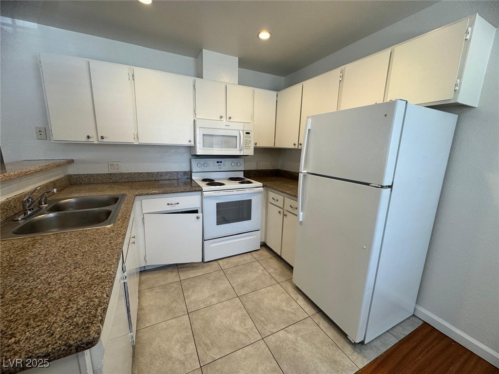 2732 Alicialynn Way, Unit A Las Vegas, NV 89121 - Photo 5 of 14 Kitchen featuring white appliances, a sink, dark countertops, recessed lighting, and white cabinetry