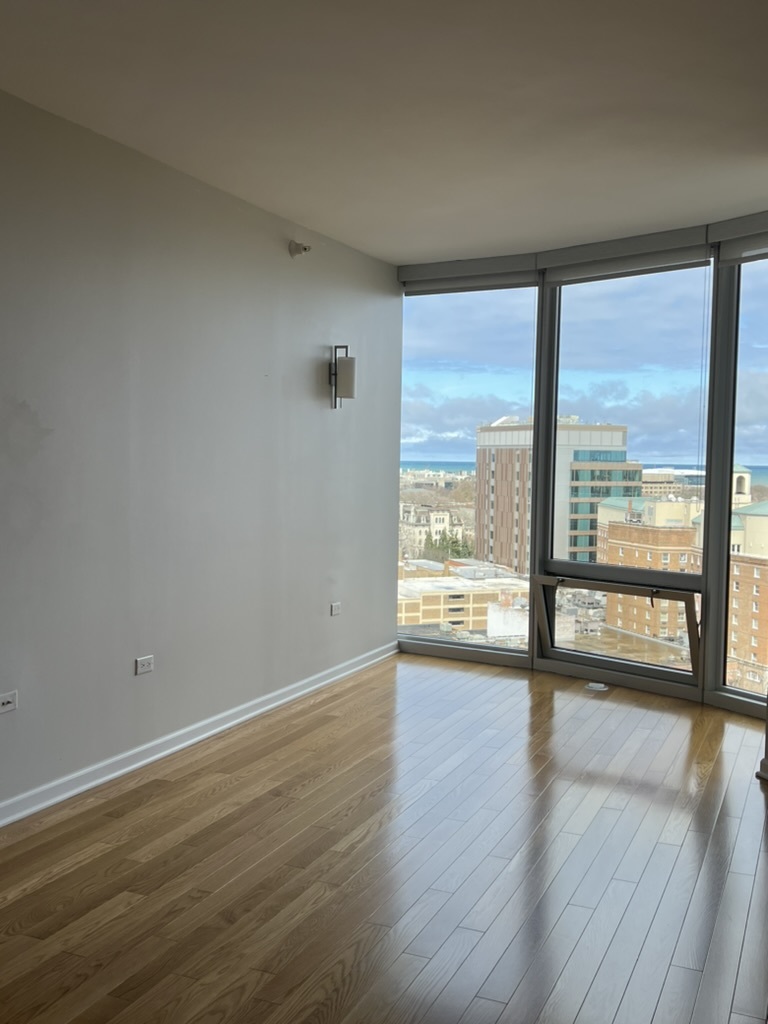 807 Davis Street, Unit 1308 Evanston, IL 60201 - Photo 3 of 16 a view of an empty room with wooden floor and a window