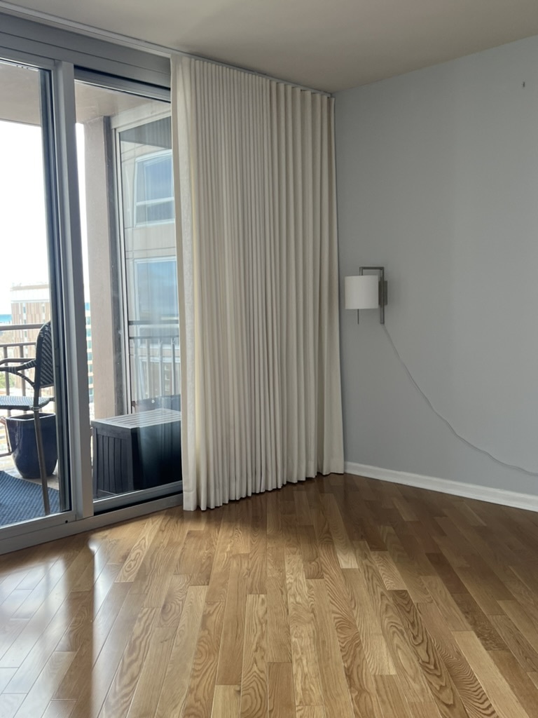 807 Davis Street, Unit 1308 Evanston, IL 60201 - Photo 8 of 16 an empty room with wooden floor and windows