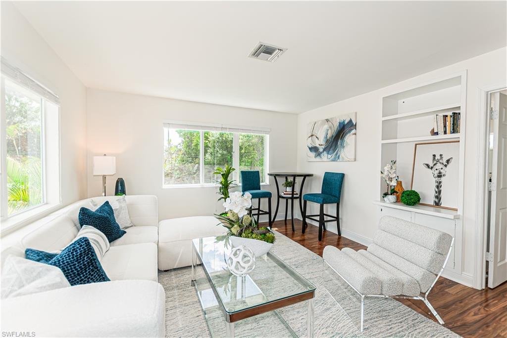 1060 Cooper Drive Naples, FL 34103 - Photo 11 of 24 Living room with wood finished floors and built in shelves