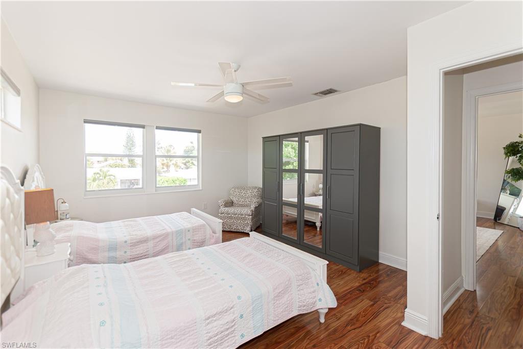 1060 Cooper Drive Naples, FL 34103 - Photo 14 of 24 Bedroom with dark wood-type flooring and ceiling fan