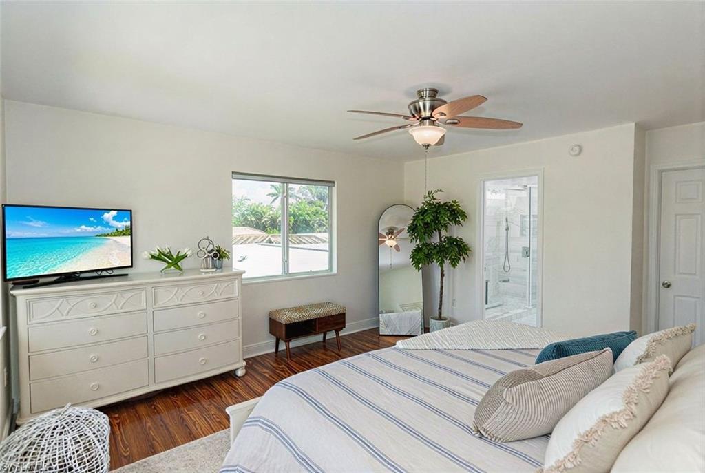 1060 Cooper Drive Naples, FL 34103 - Photo 17 of 24 Bedroom featuring dark wood-style floors, a ceiling fan, and ensuite bath