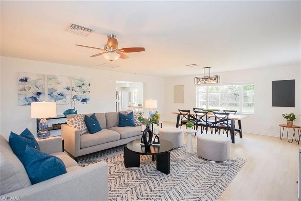 1060 Cooper Drive Naples, FL 34103 - Photo 3 of 7 Living room with a ceiling fan and wood finished floors