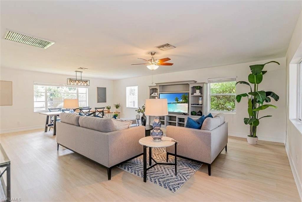 1060 Cooper Drive Naples, FL 34103 - Photo 5 of 24 Living room with light wood-style floors and a ceiling fan