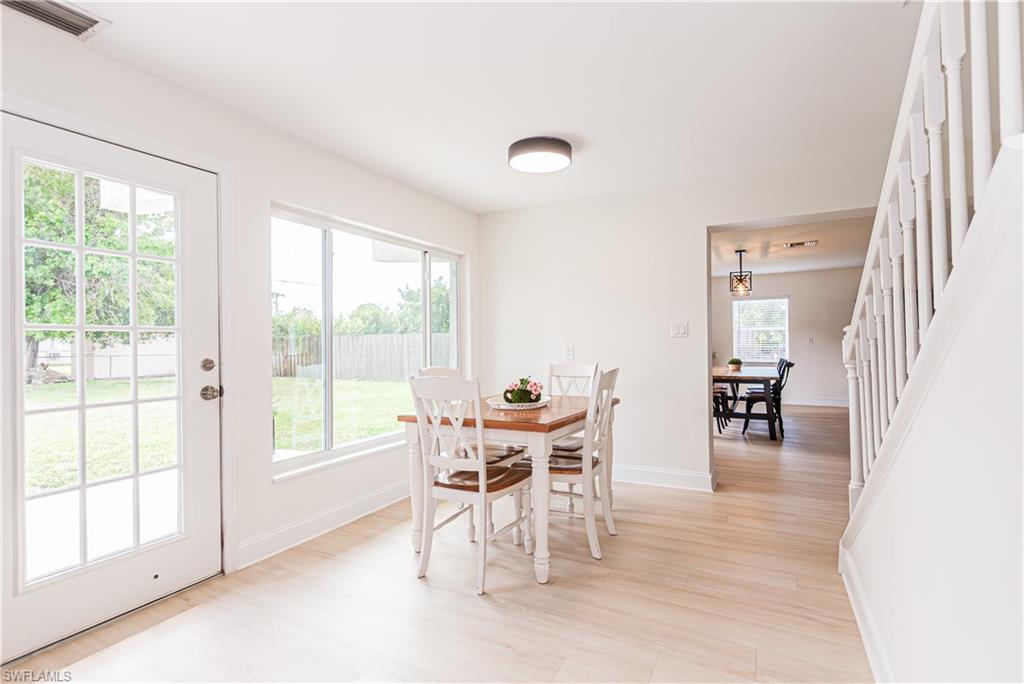 1060 Cooper Drive Naples, FL 34103 - Photo 7 of 24 Dining area with light wood finished floors and stairs