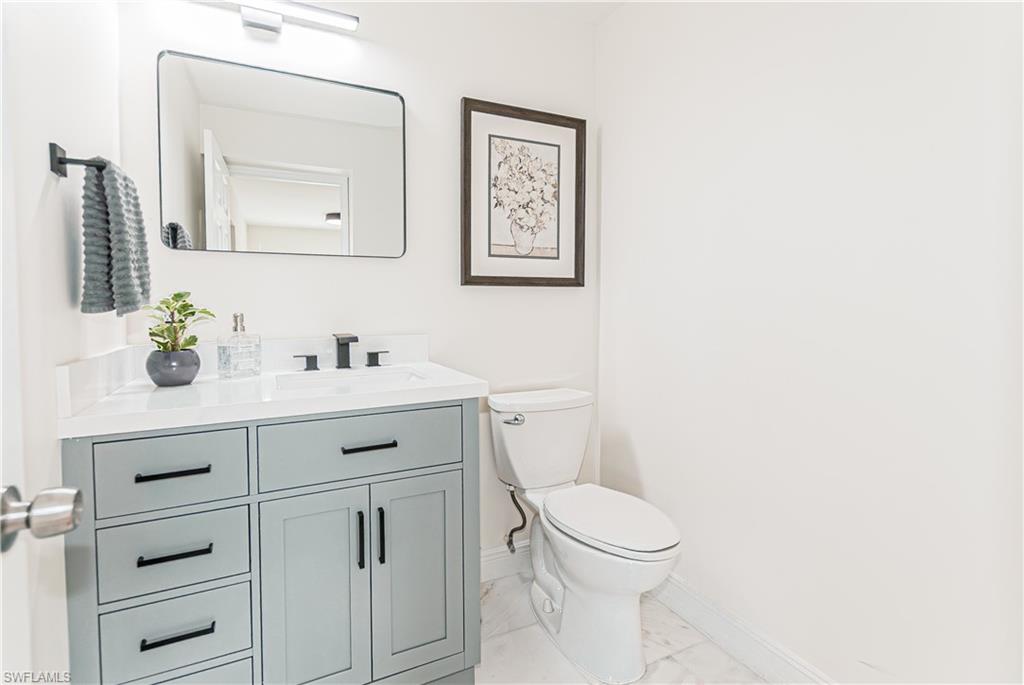 1060 Cooper Drive Naples, FL 34103 - Photo 10 of 24 Bathroom with vanity and light marble finish flooring