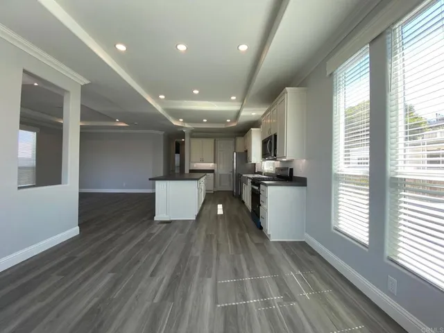 a view of kitchen with windows and refrigerator