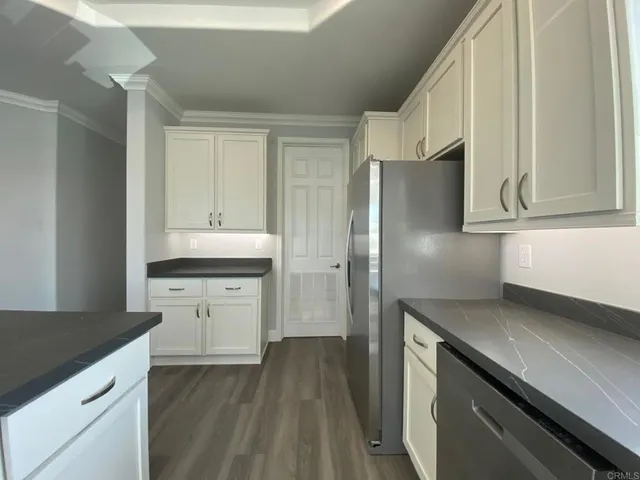a kitchen with a refrigerator and a sink