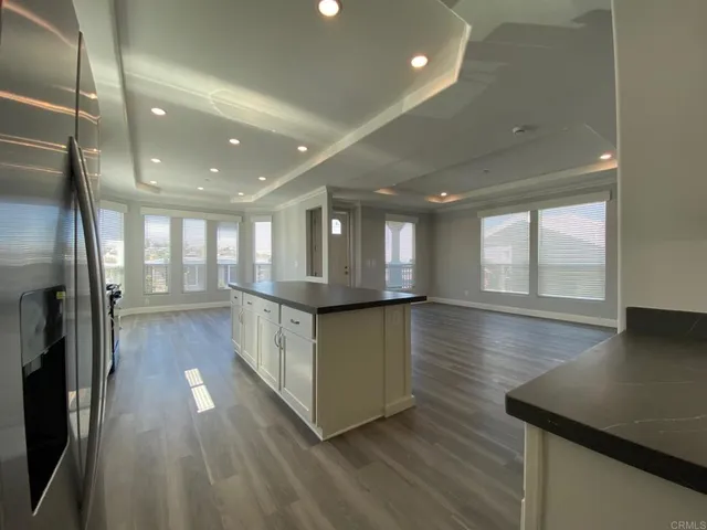 a kitchen with counter top space and wooden floor