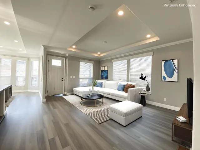 a living room with furniture and wooden floor