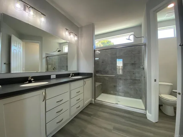 a bathroom with double sink and a mirror