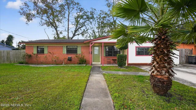a front view of house with yard and green space