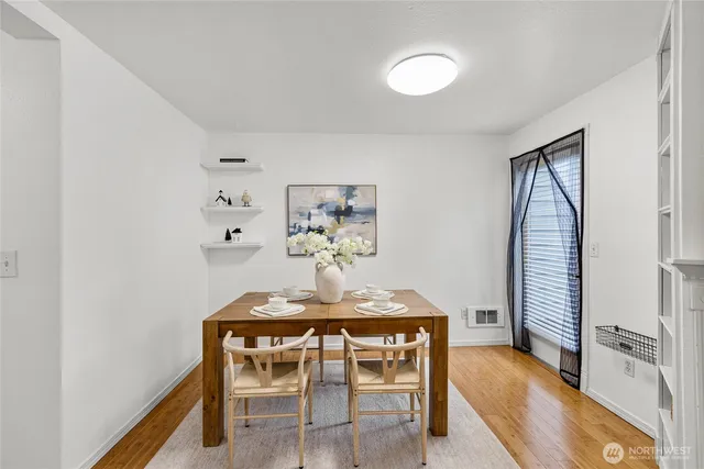 a dining room with furniture and wooden floor
