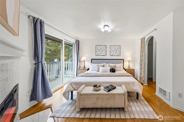 a bedroom with a bed and a large window