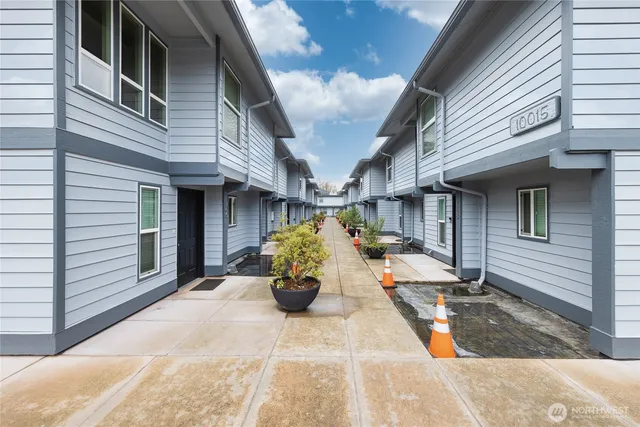 a view of a patio with table and chairs and wooden fence