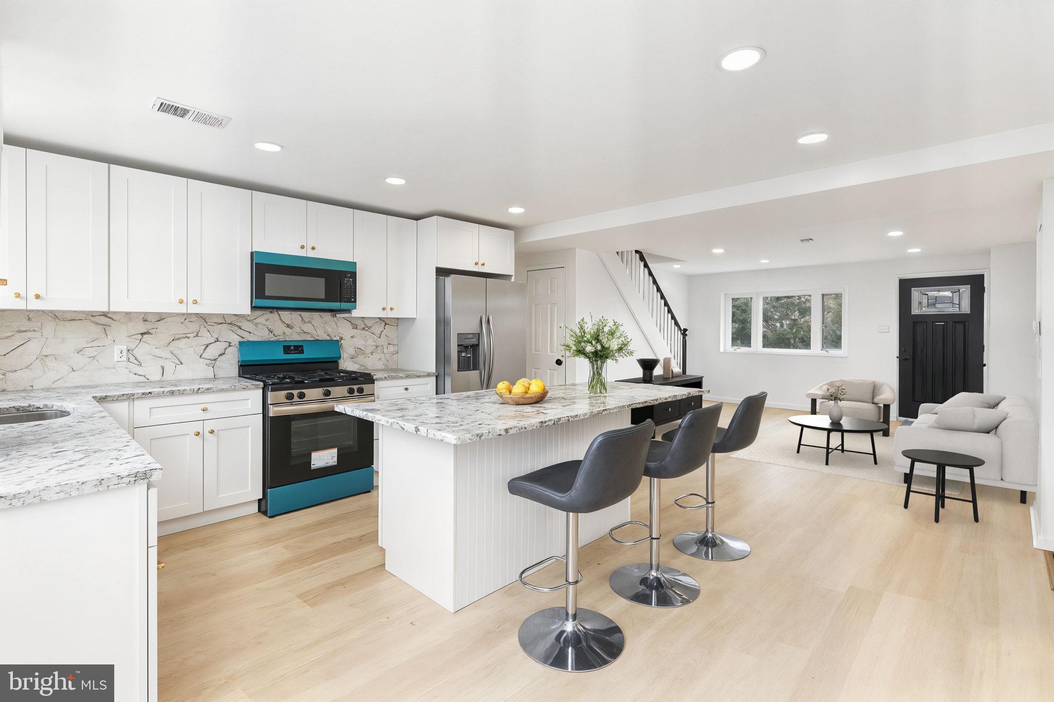 7703 Gilbert Street Philadelphia, PA 19150 - Photo 1 of 37 a kitchen with counter space appliances and a view of living room