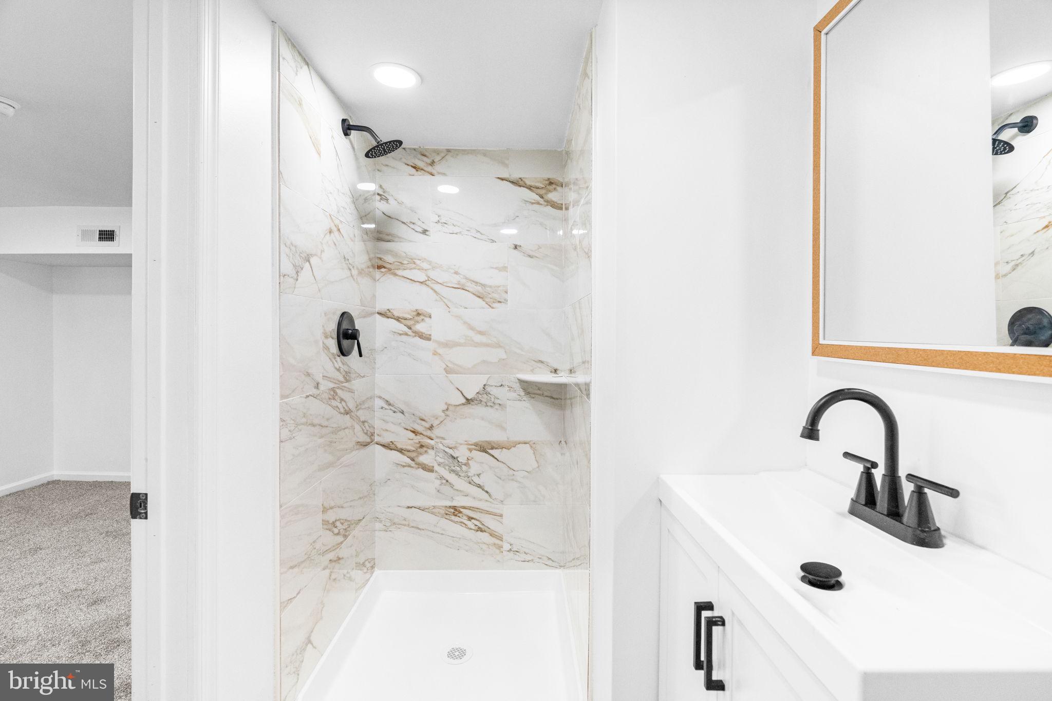7703 Gilbert Street Philadelphia, PA 19150 - Photo 16 of 37 a bathroom with a sink and mirror