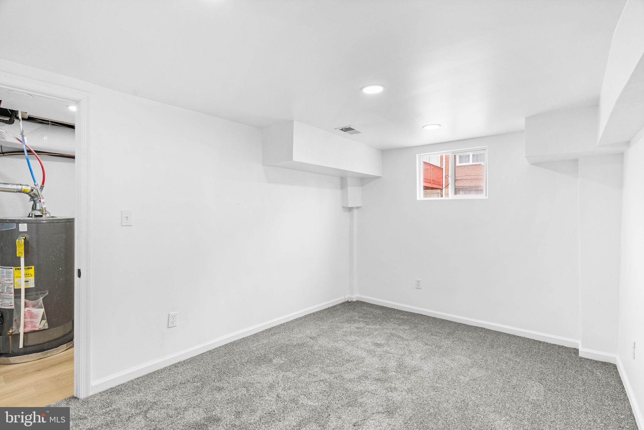 7703 Gilbert Street Philadelphia, PA 19150 - Photo 19 of 37 an empty room with a hallway and wooden floor
