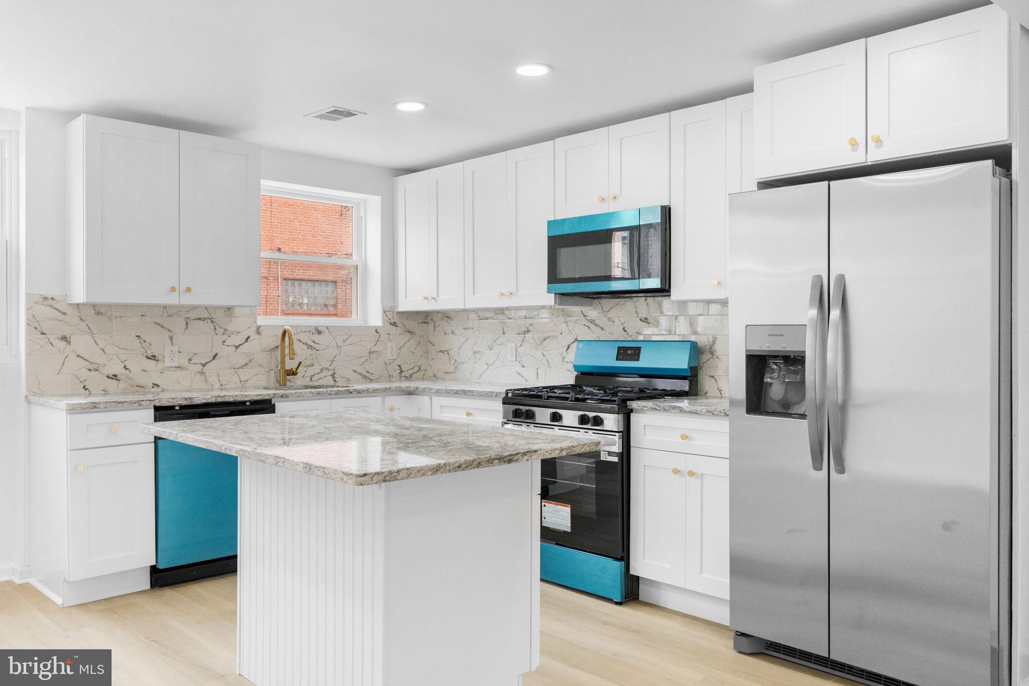 7703 Gilbert Street Philadelphia, PA 19150 - Photo 4 of 37 a kitchen with stainless steel appliances granite countertop a stove a refrigerator and a sink