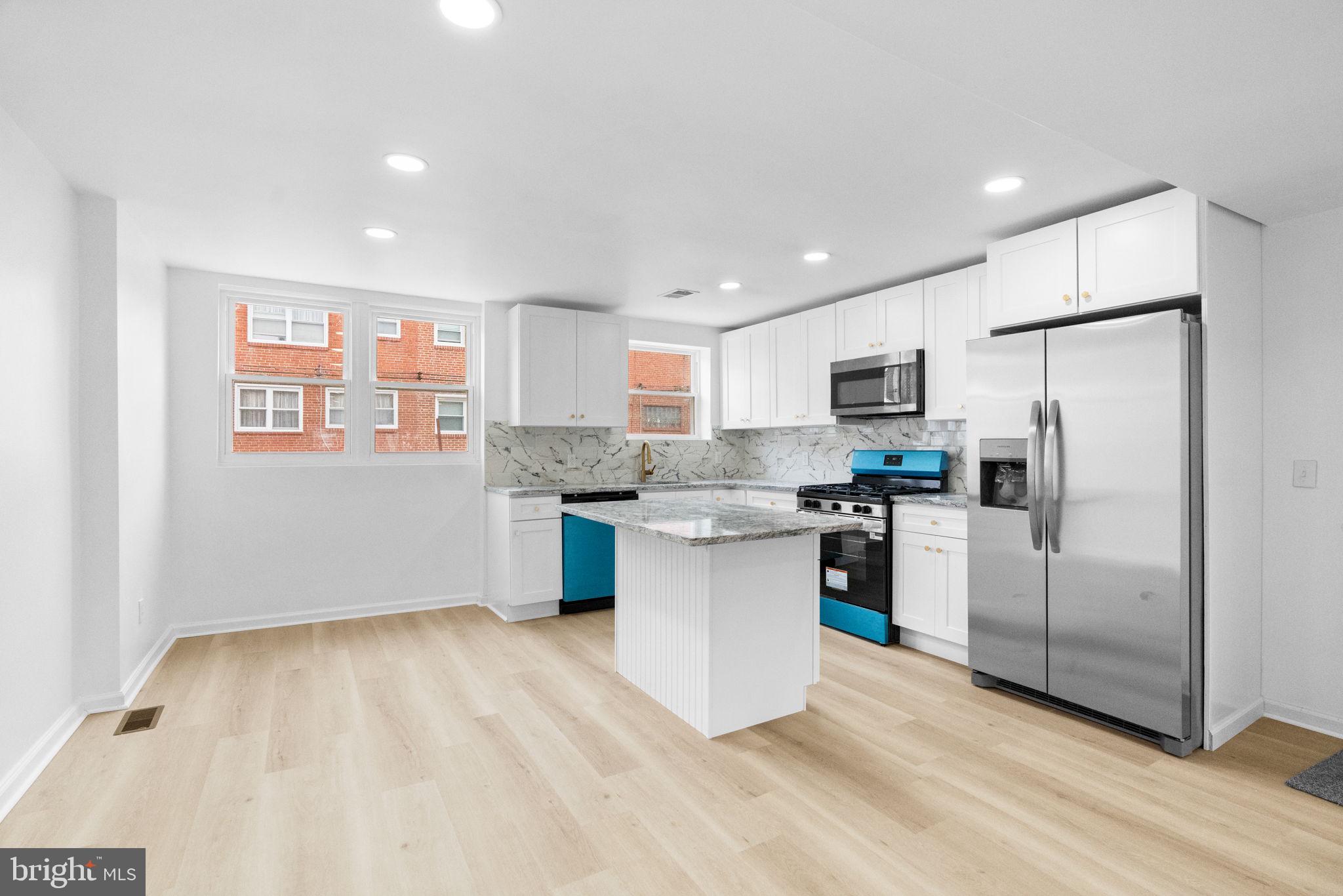 7703 Gilbert Street Philadelphia, PA 19150 - Photo 5 of 37 a kitchen with stainless steel appliances a refrigerator sink and microwave