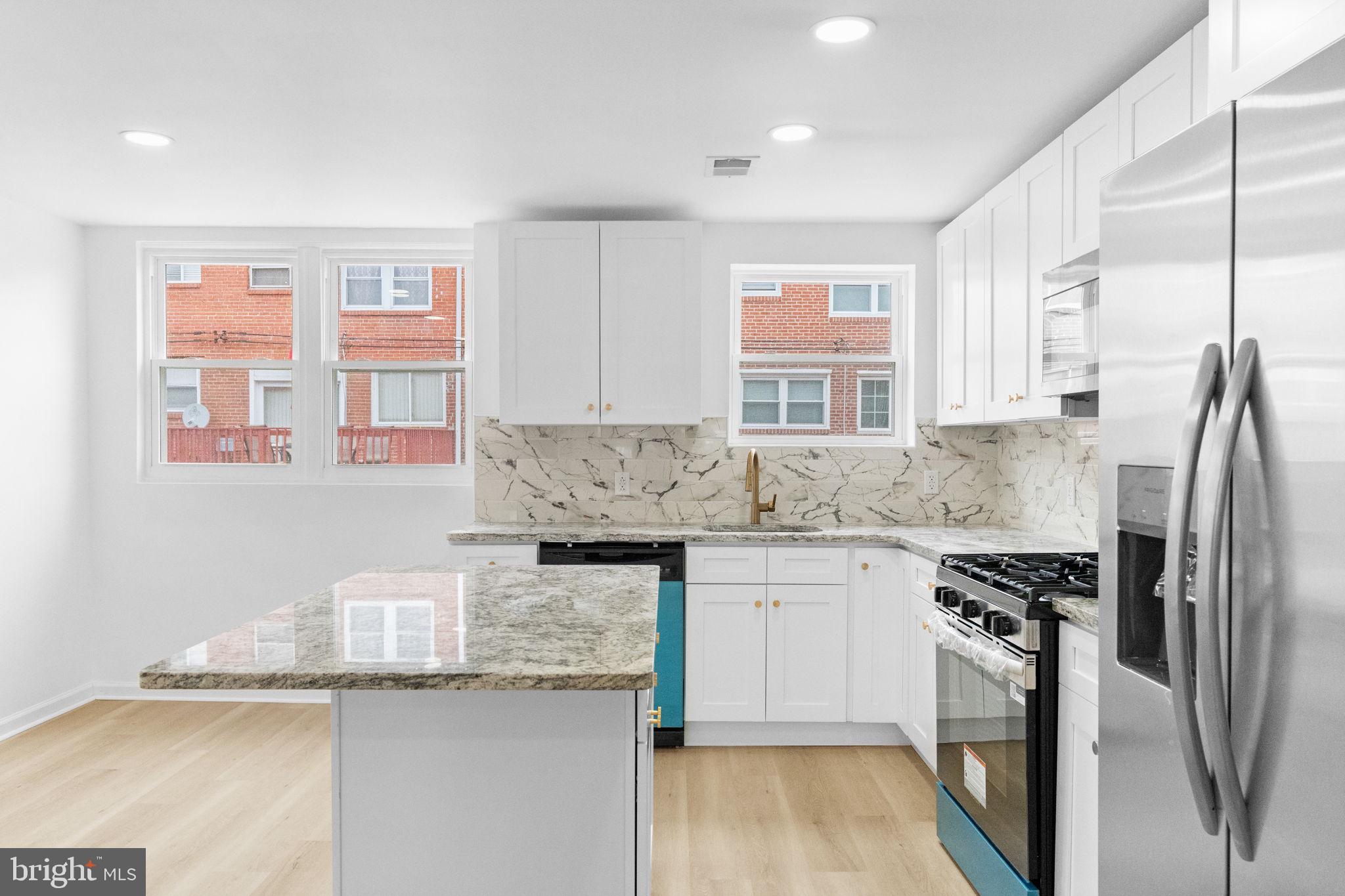 7703 Gilbert Street Philadelphia, PA 19150 - Photo 6 of 37 a kitchen with stainless steel appliances granite countertop a sink stove and refrigerator
